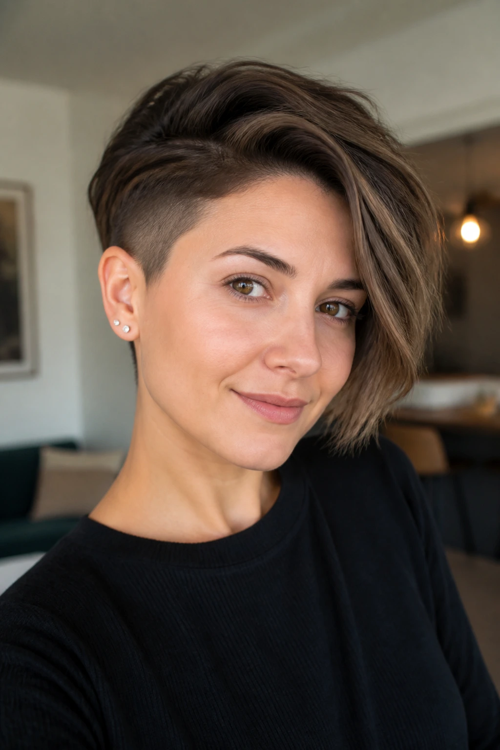 Close-up of a woman with soft undercut and swept top in warm interior light