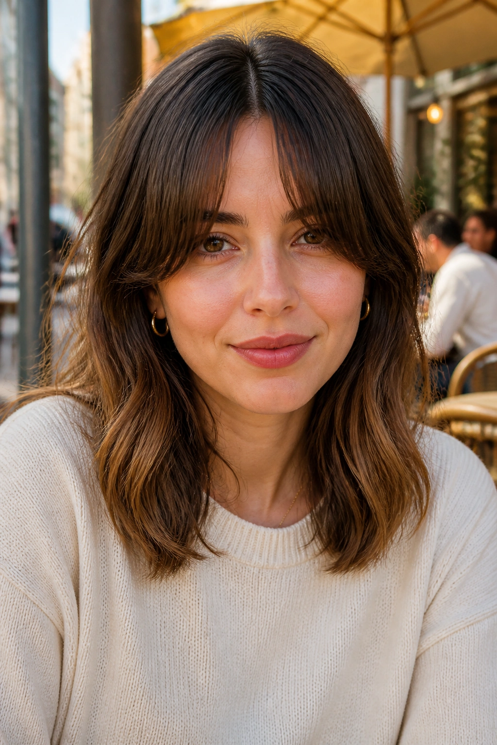 Portrait of a woman with a split fringe and a center opening.