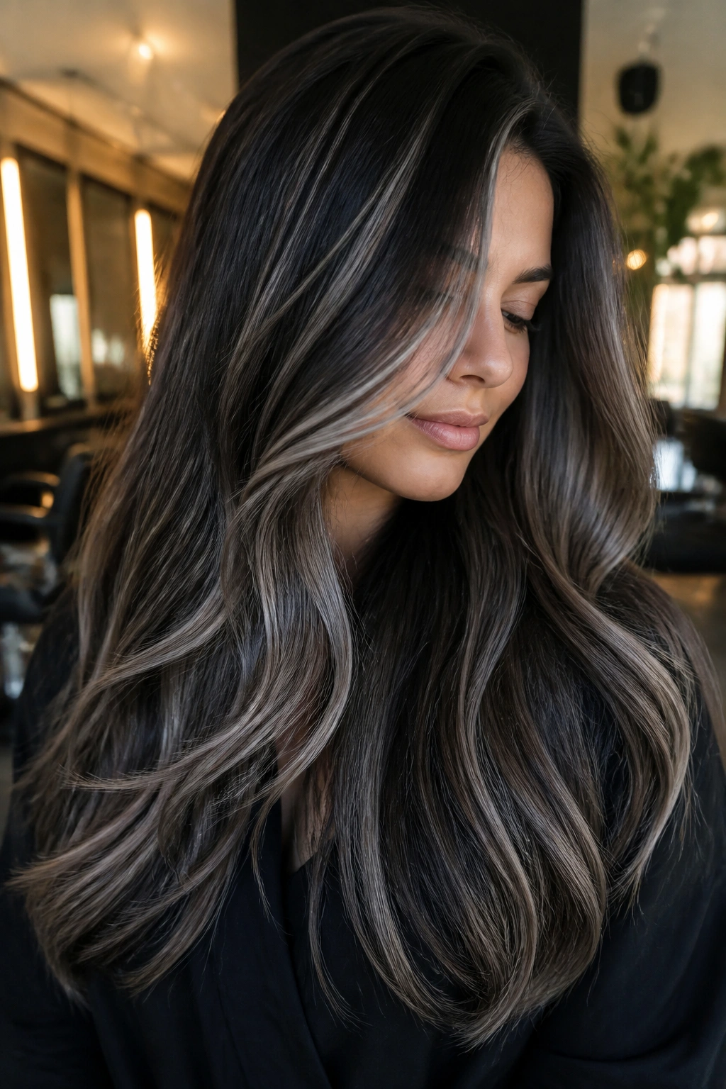 Portrait of a real woman with steel ribbon balayage on thick brown hair