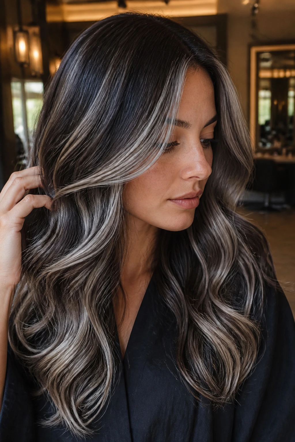Close-up of brunette with steel silver balayage ribbons around face