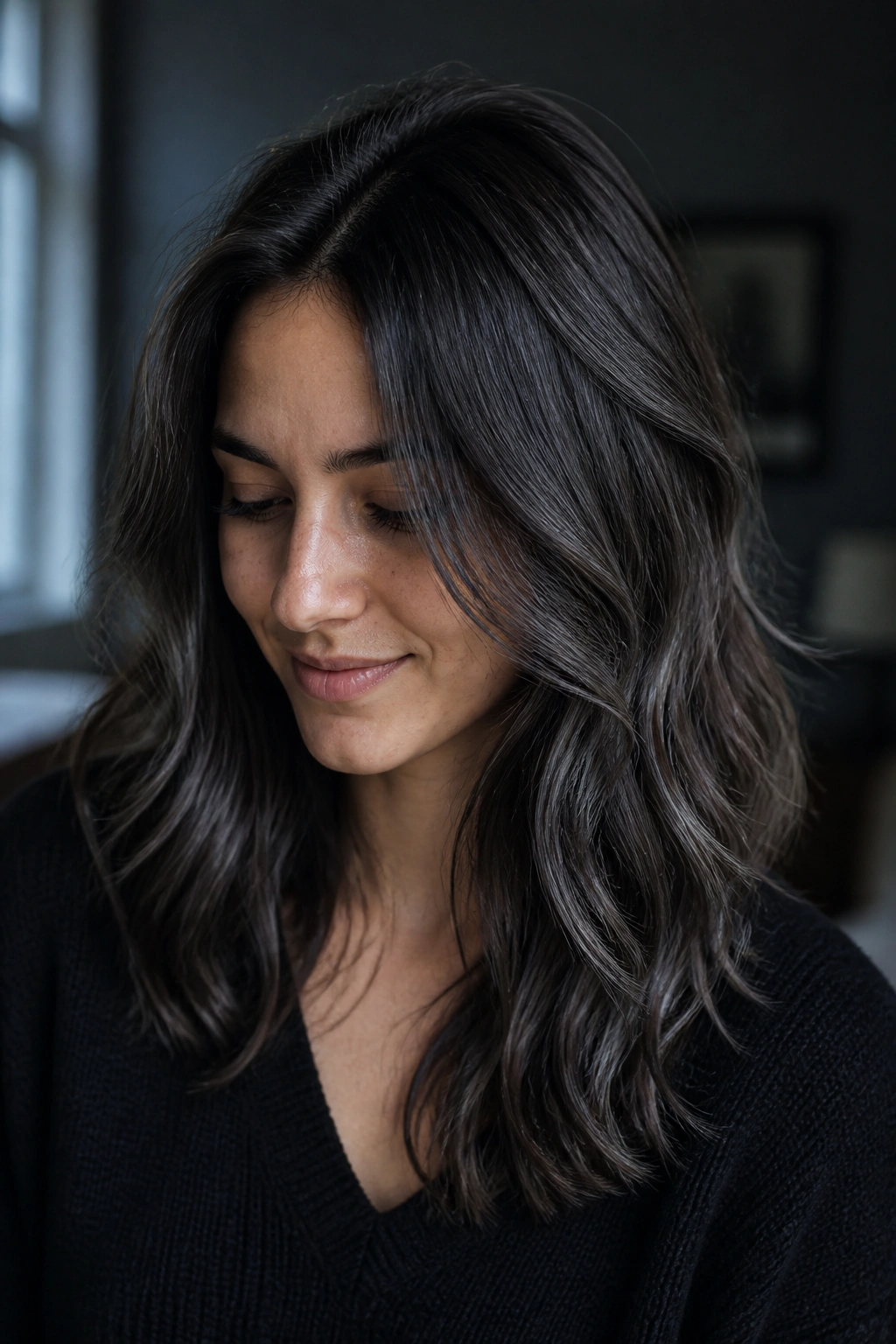 Portrait of a real woman with storm cloud gray highlights on dark brown hair.