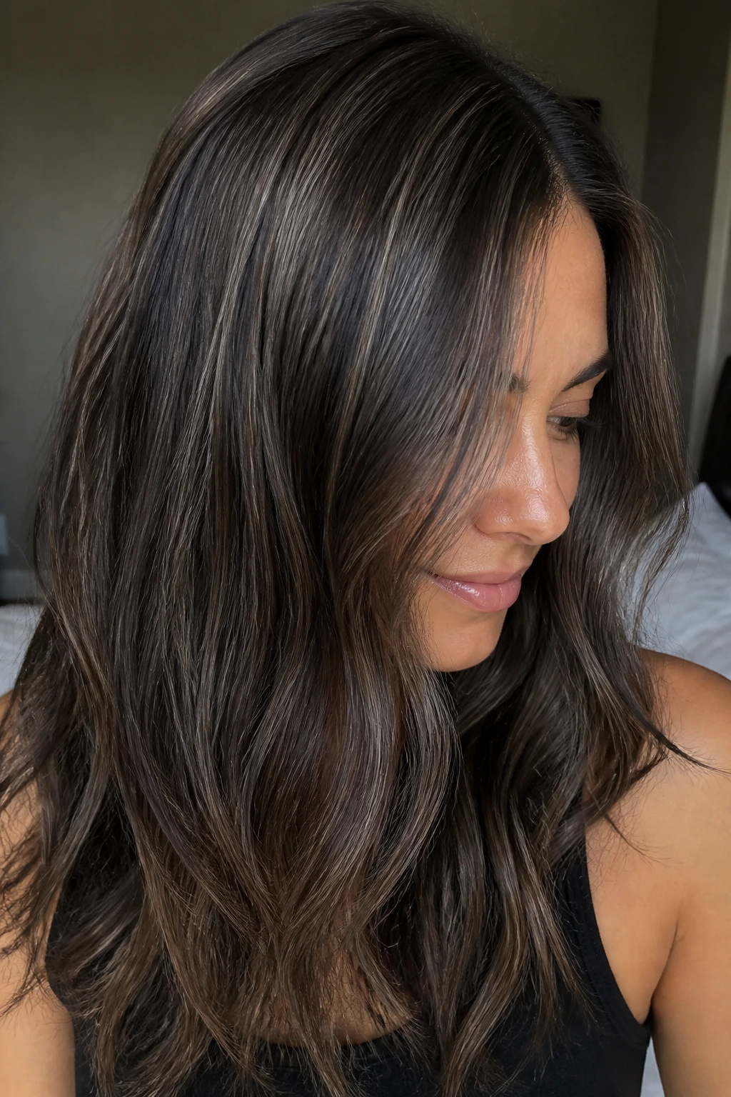 Close-up portrait of a real person showing stormy brunette babylights with fine highlights