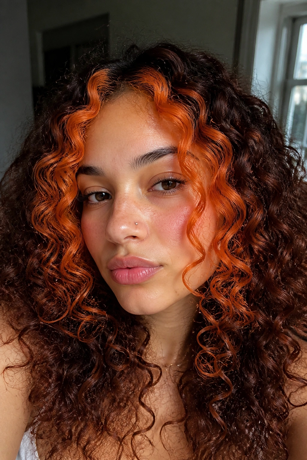 Close-up of a real person with tangerine money pieces on curls