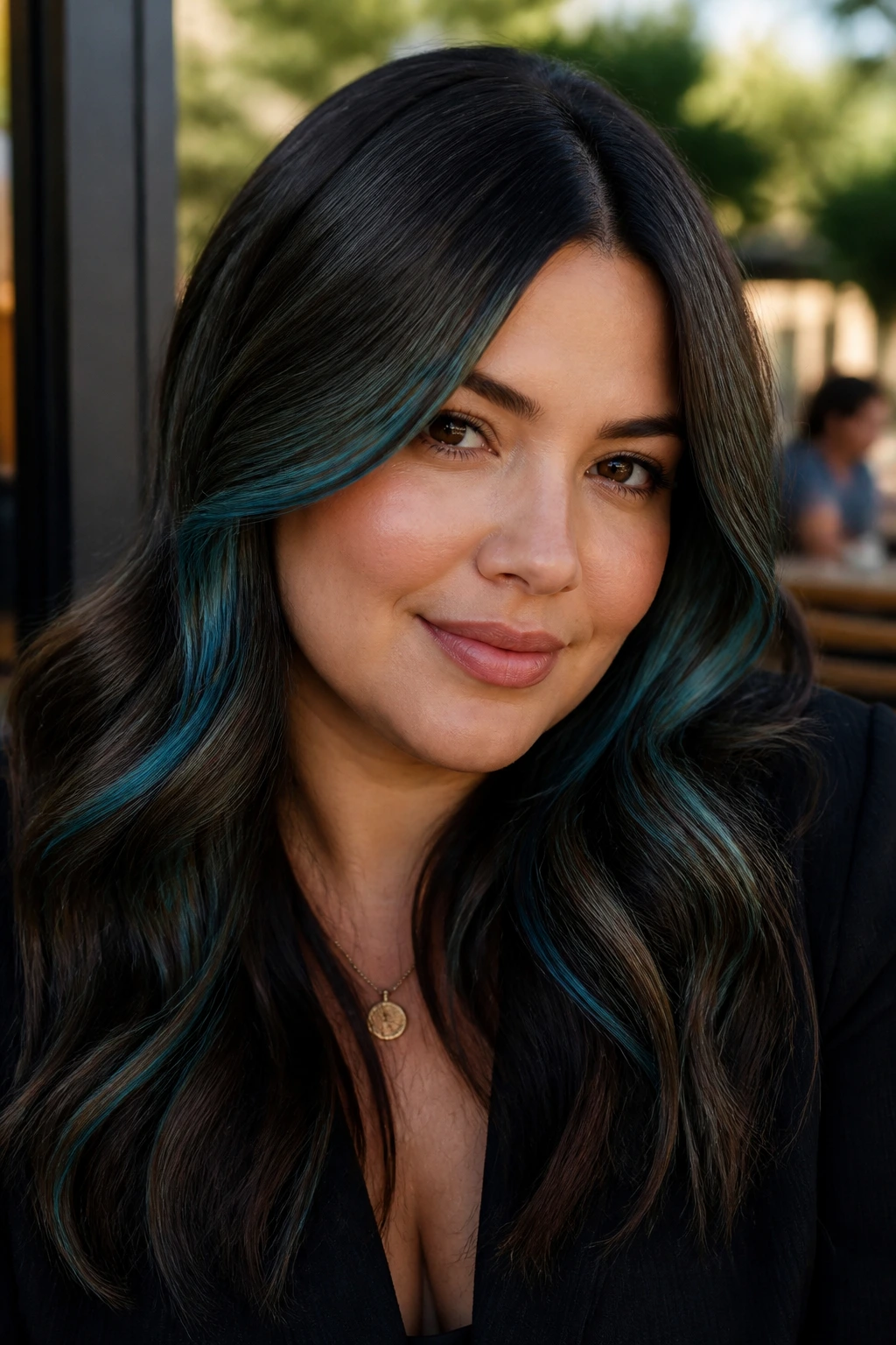 Close-up of brunette waves with teal contour pieces at temple