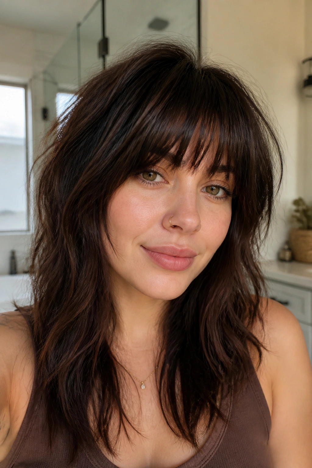 Close-up of a person with thick, textured bangs on thick hair