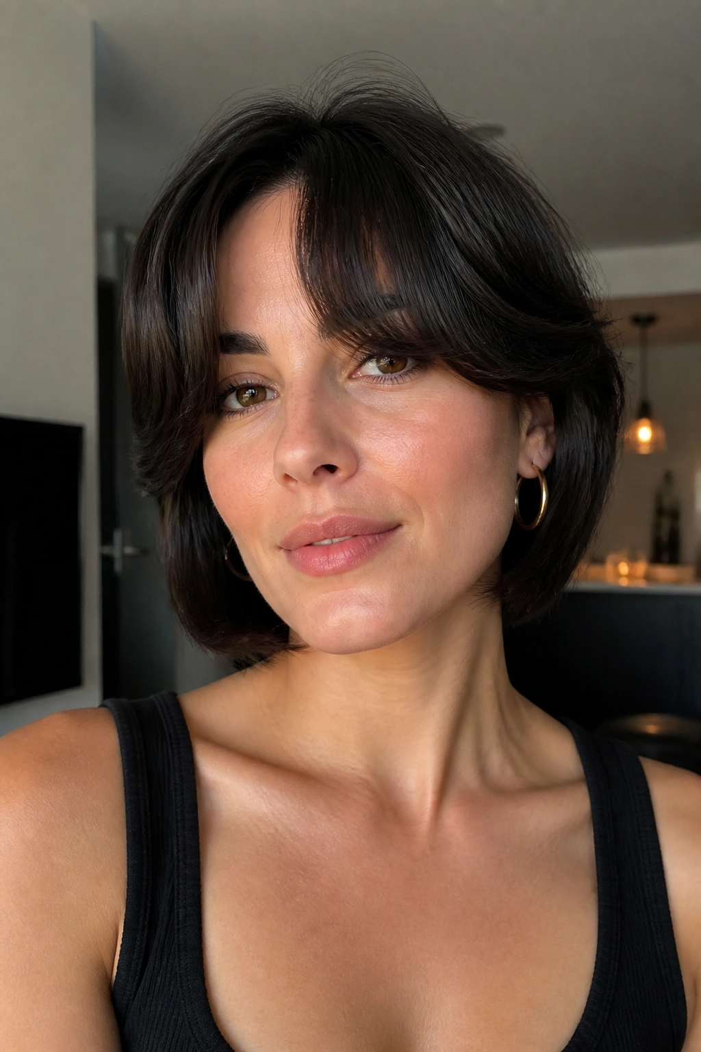 Close-up of a real person with thick sculpted curtain bangs in a modern apartment