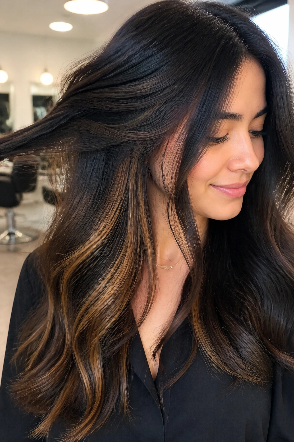 Real woman with hidden toasted almond peekaboo highlights under the top layer