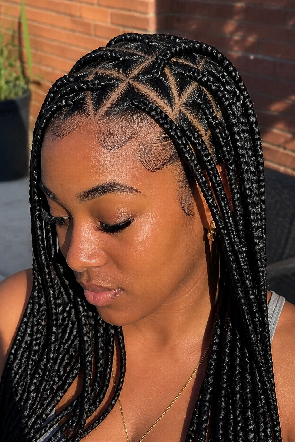 Close-up of a real woman with triangle-part braids along the scalp