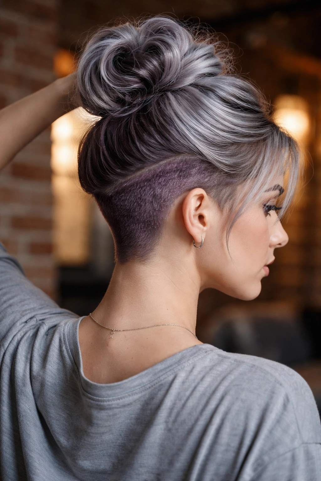 Close-up of a real person showing metallic mauve undercut under silver hair.