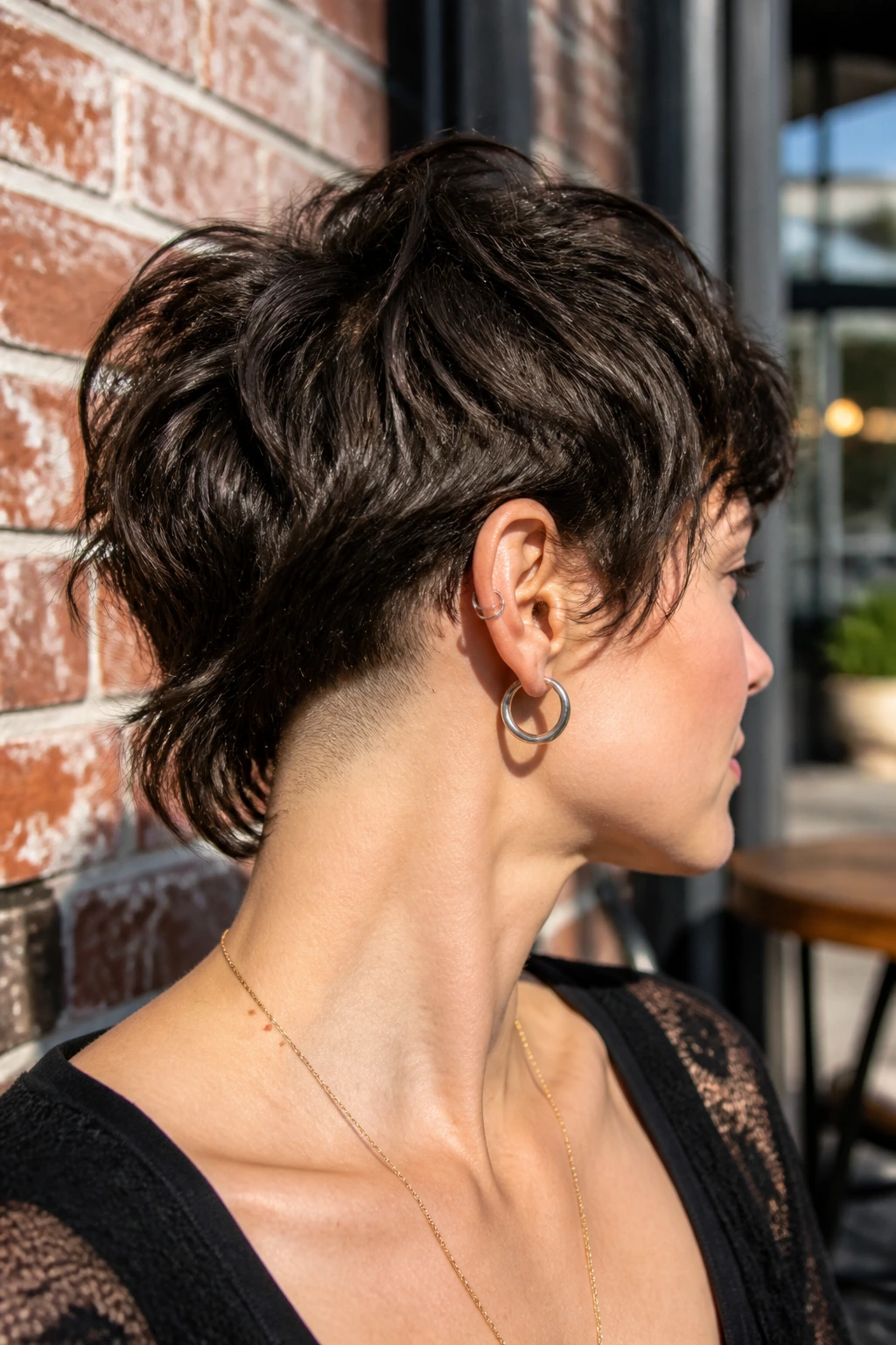 Close-up portrait of a person with an undercut shag at the nape.