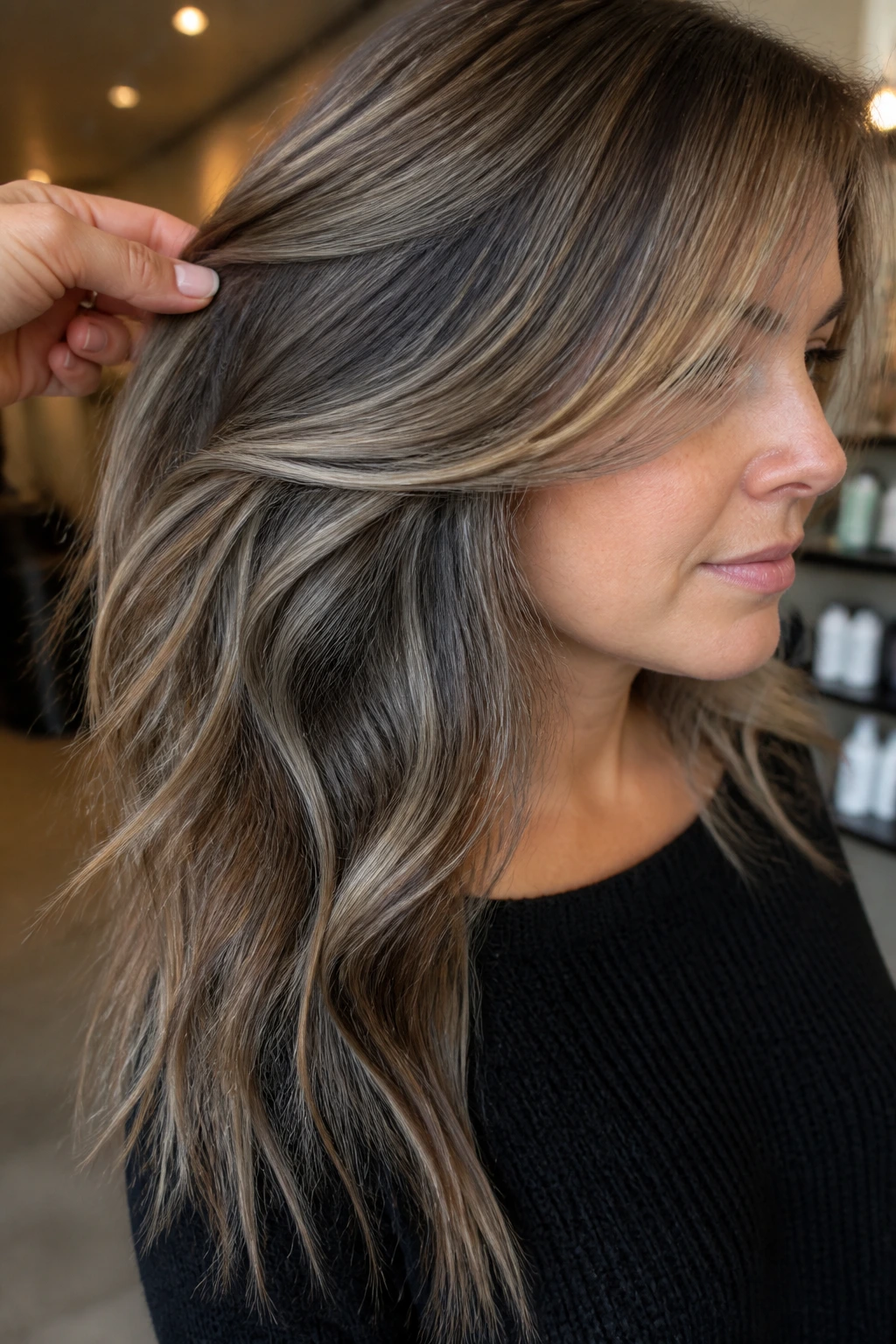 Close-up showing cooler underlayer lowlights adding shape in hair on a real person
