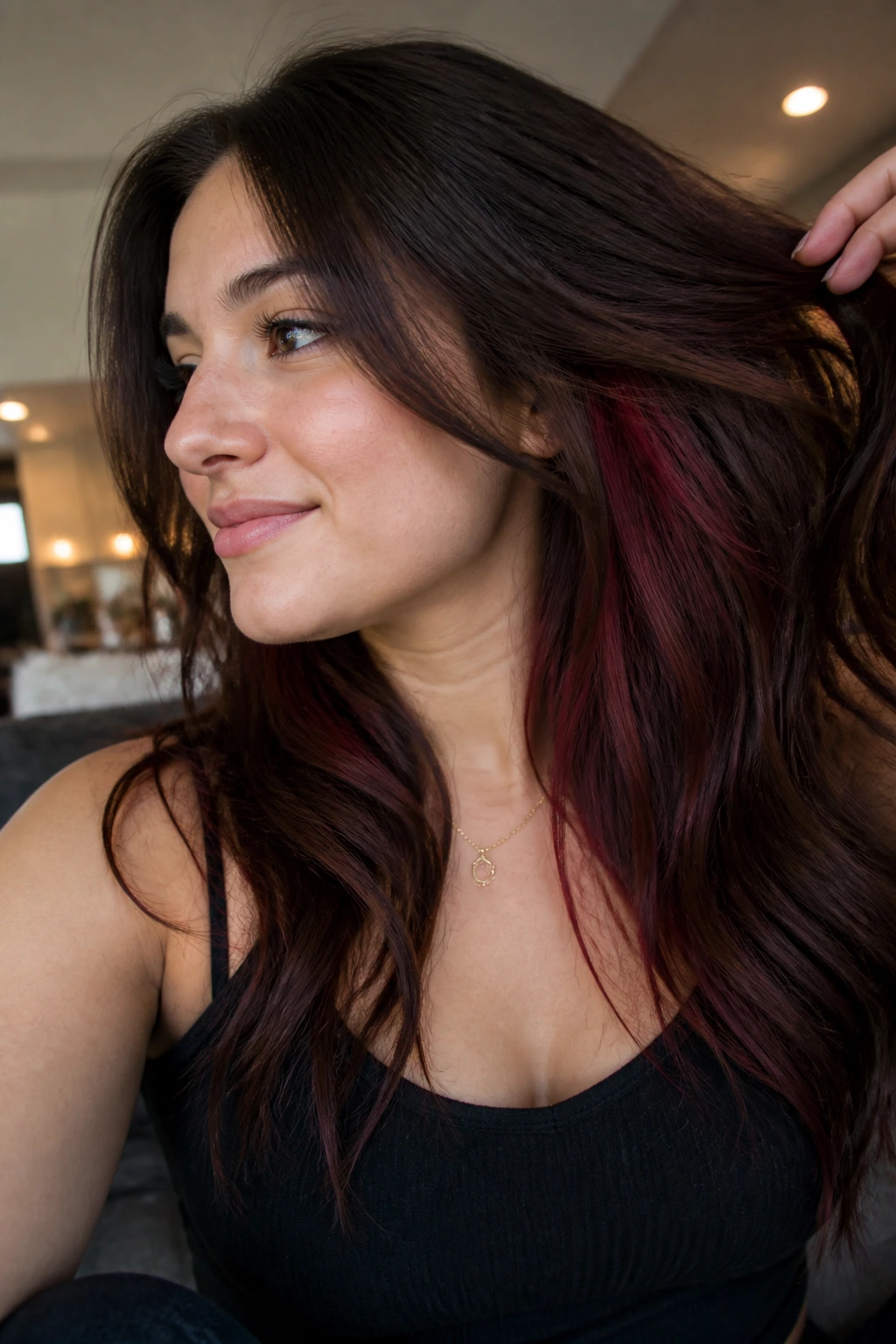 Brown hair with burgundy underlights visible when the hair moves