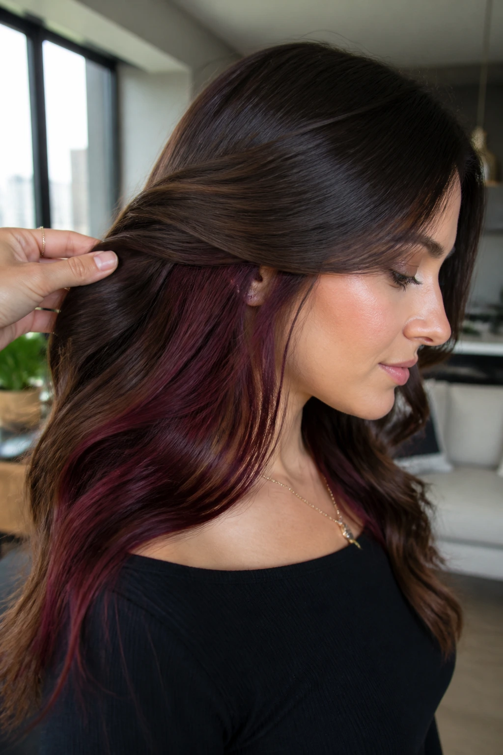 Close-up of a real person with burgundy underlights visible at the nape under a brown top layer
