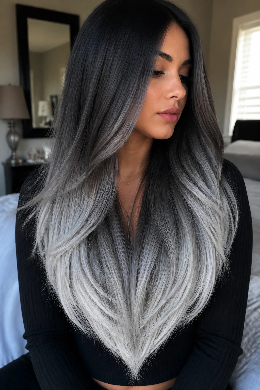 Close-up of long hair with a V-cut and silver ribbons following the cut line