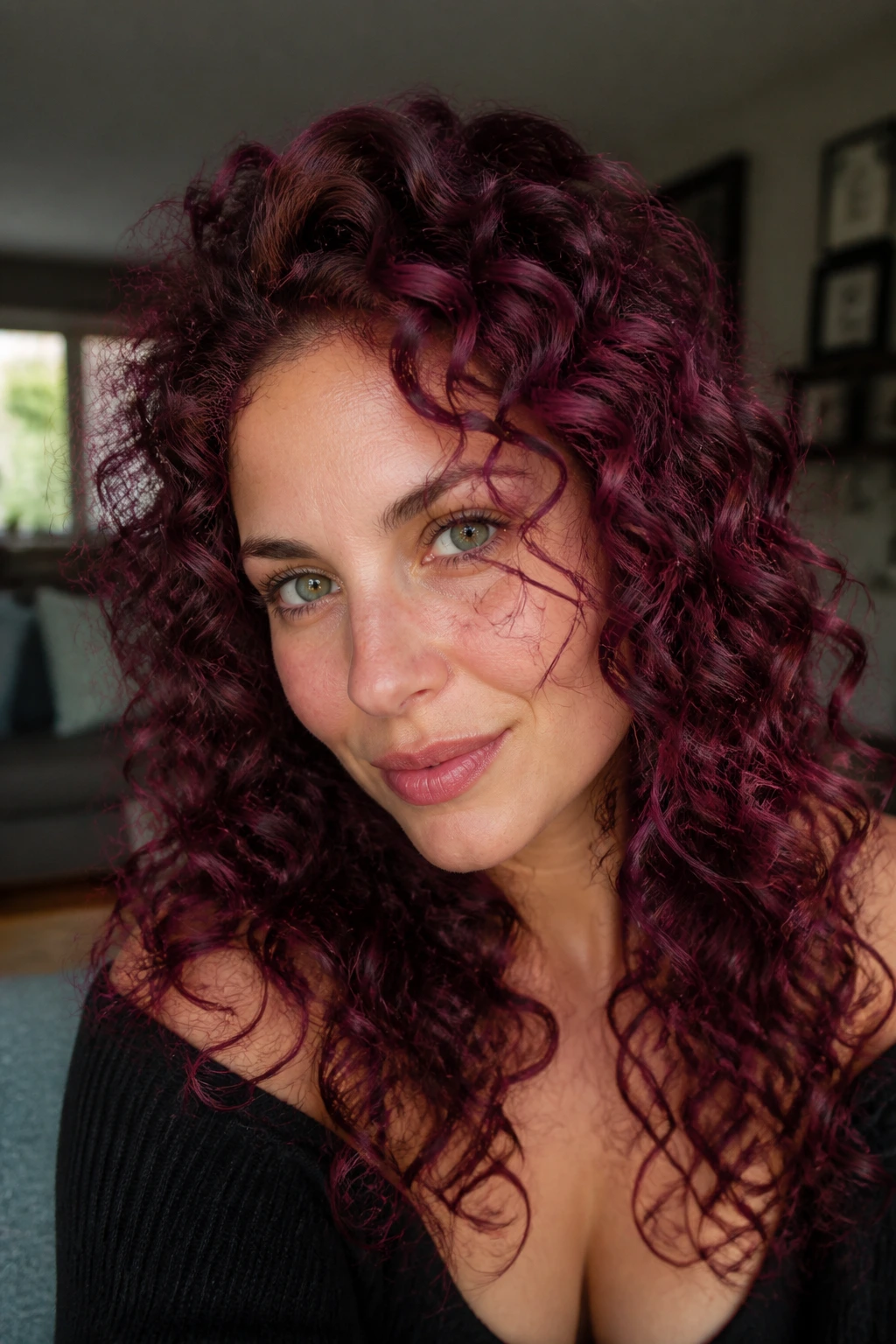 Close-up portrait of a woman with violet cherry curls.