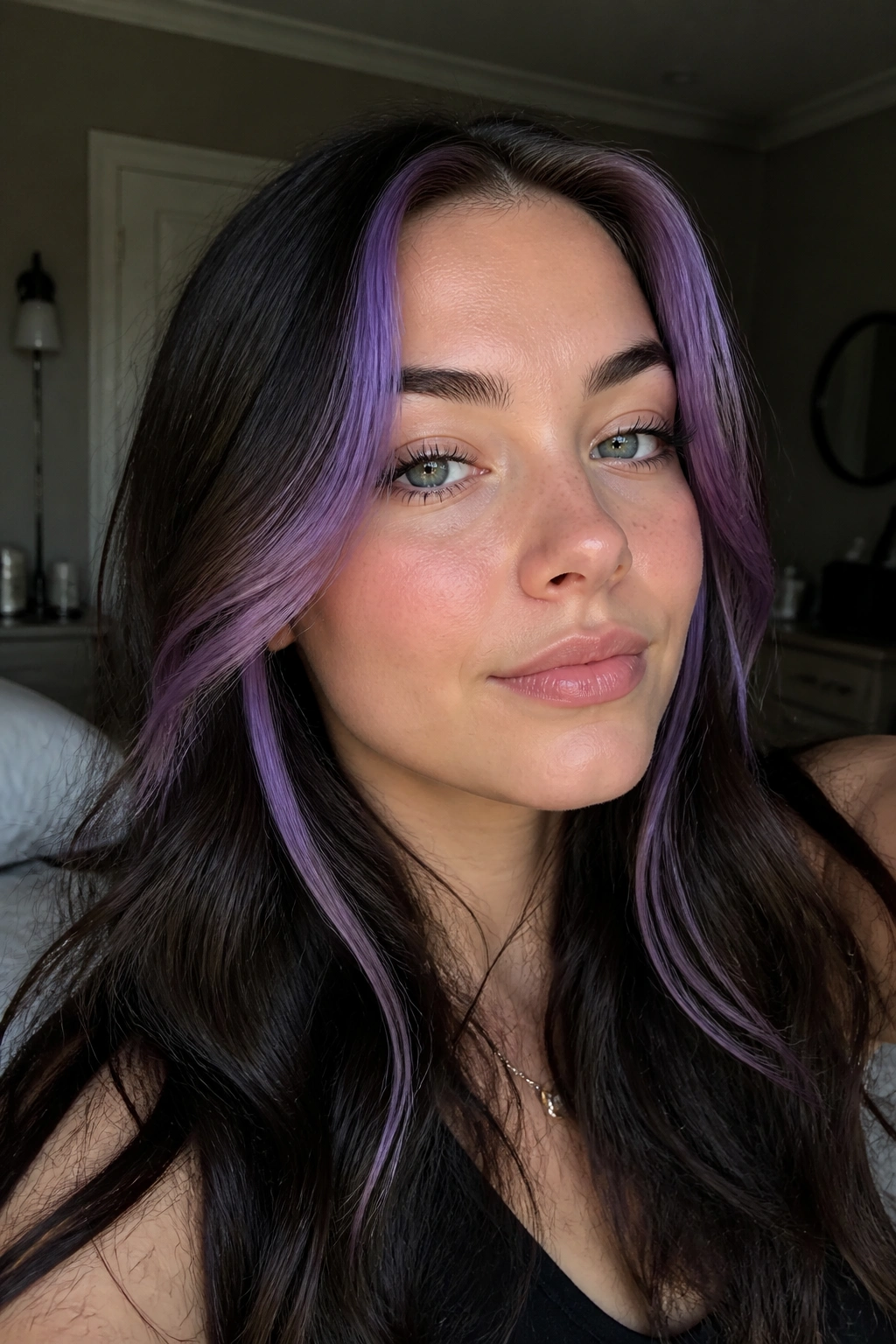 Close-up of violet face-framing money pieces on a cool-skinned person.