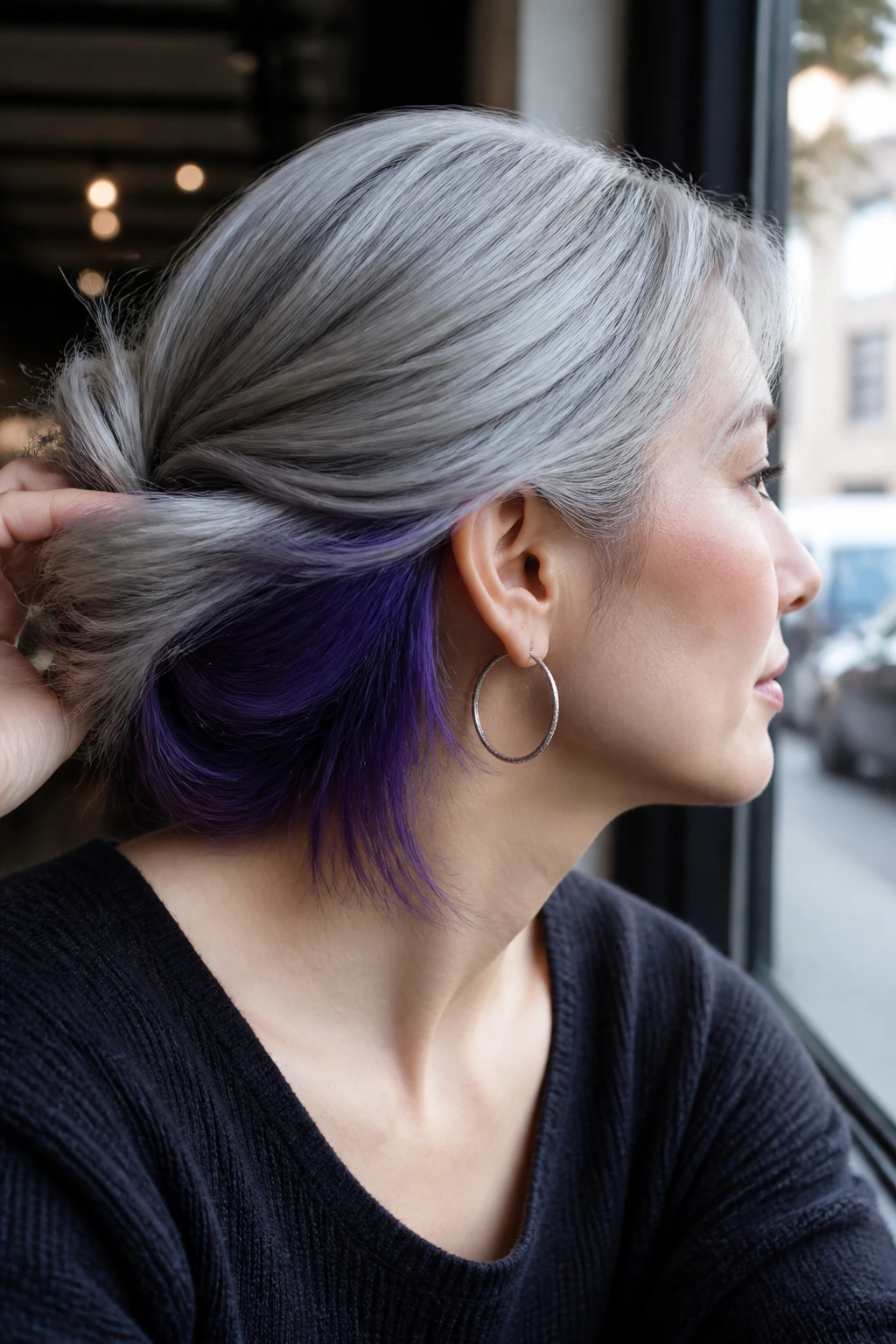 Portrait of real woman with silver top and violet peekaboo under layers.
