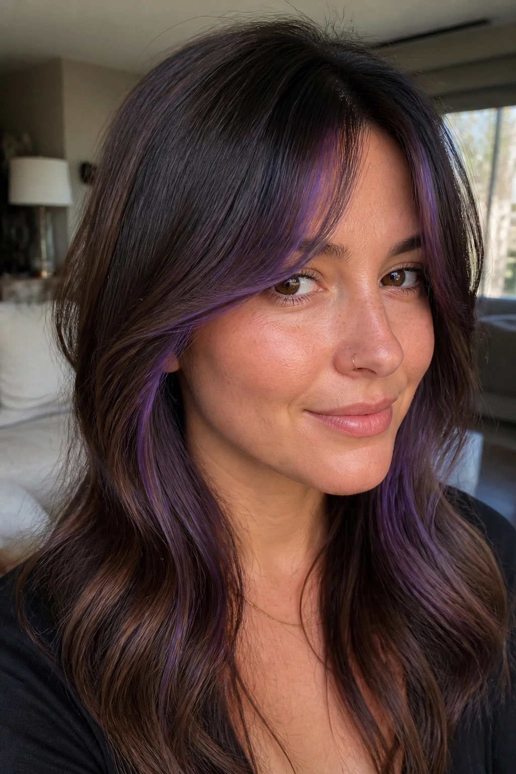 Close-up of a real woman with violet streaks under curtain bangs
