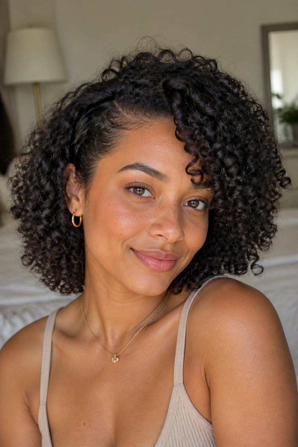 Close-up portrait of a real woman with wash-and-go ringlets and a soft side part