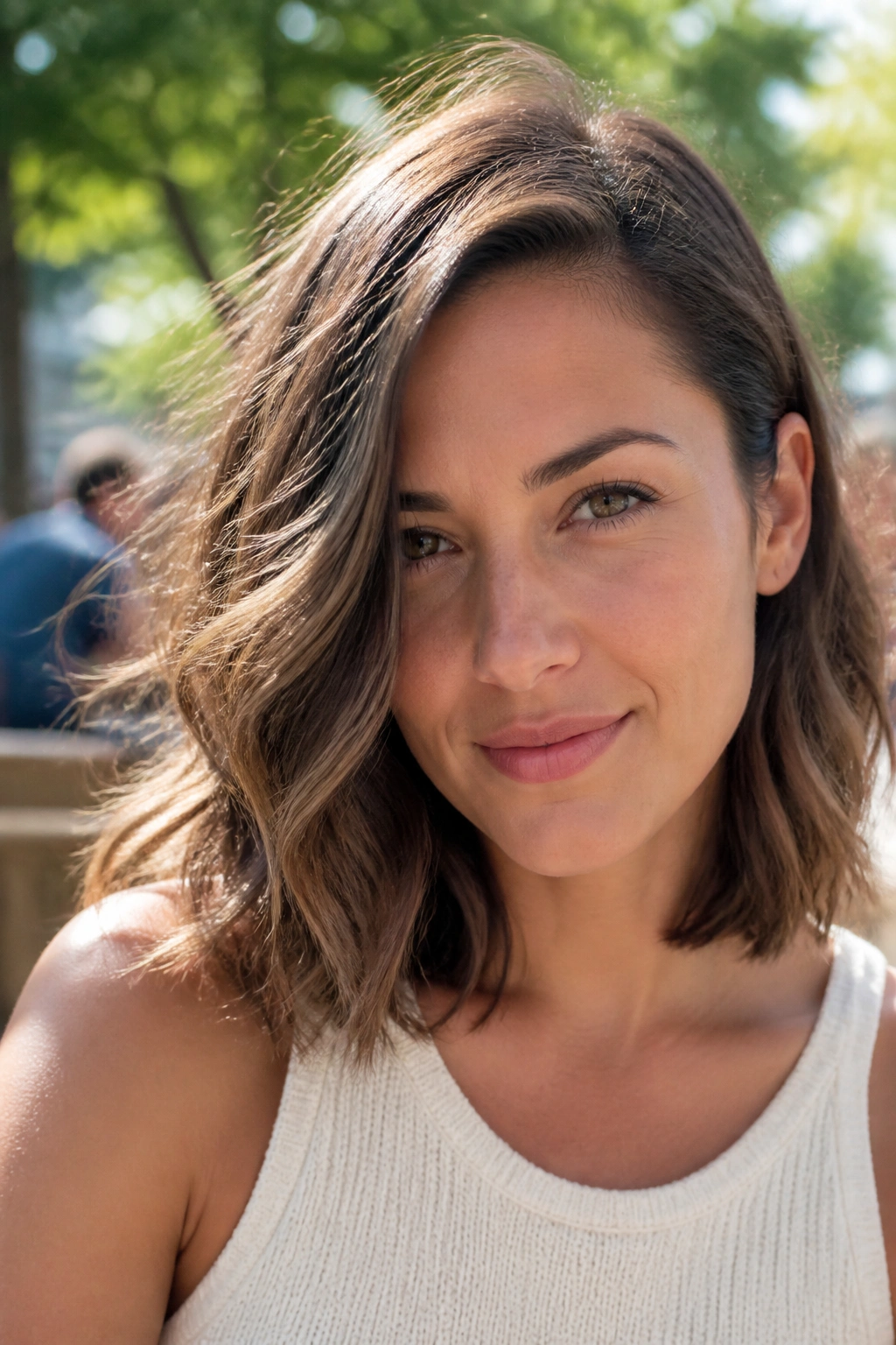 Portrait of a woman with an off-center wave lob and collarbone-length waves.