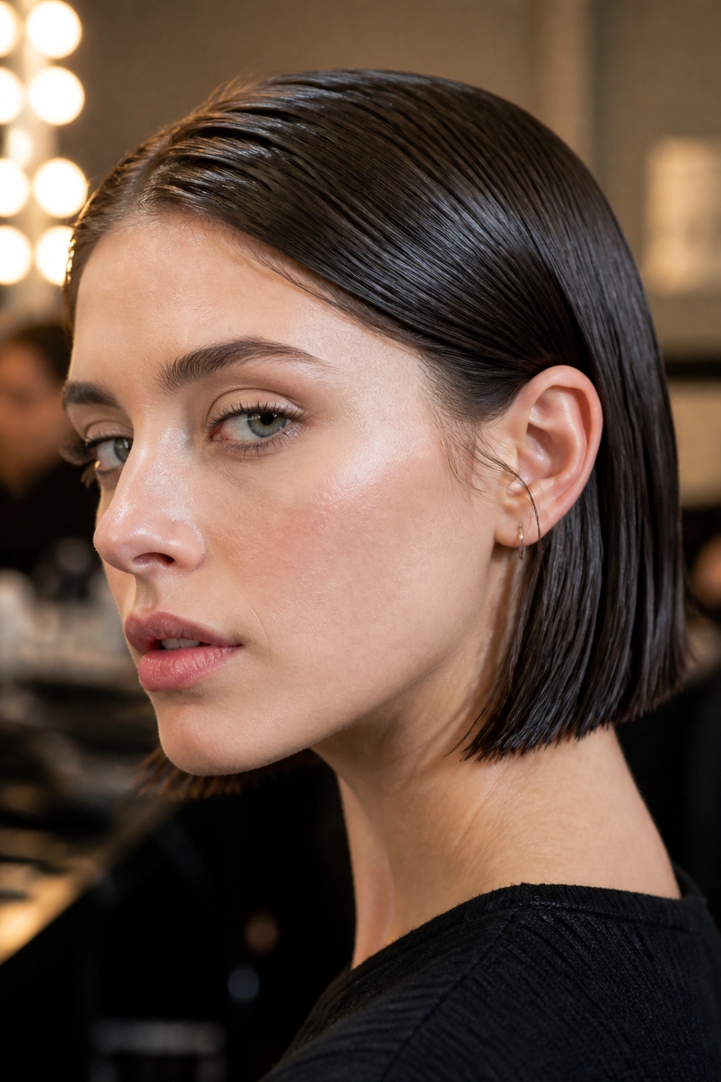 Close-up portrait of a real woman with a wet-look French Bob, glossy sleek hairstyle for fine hair