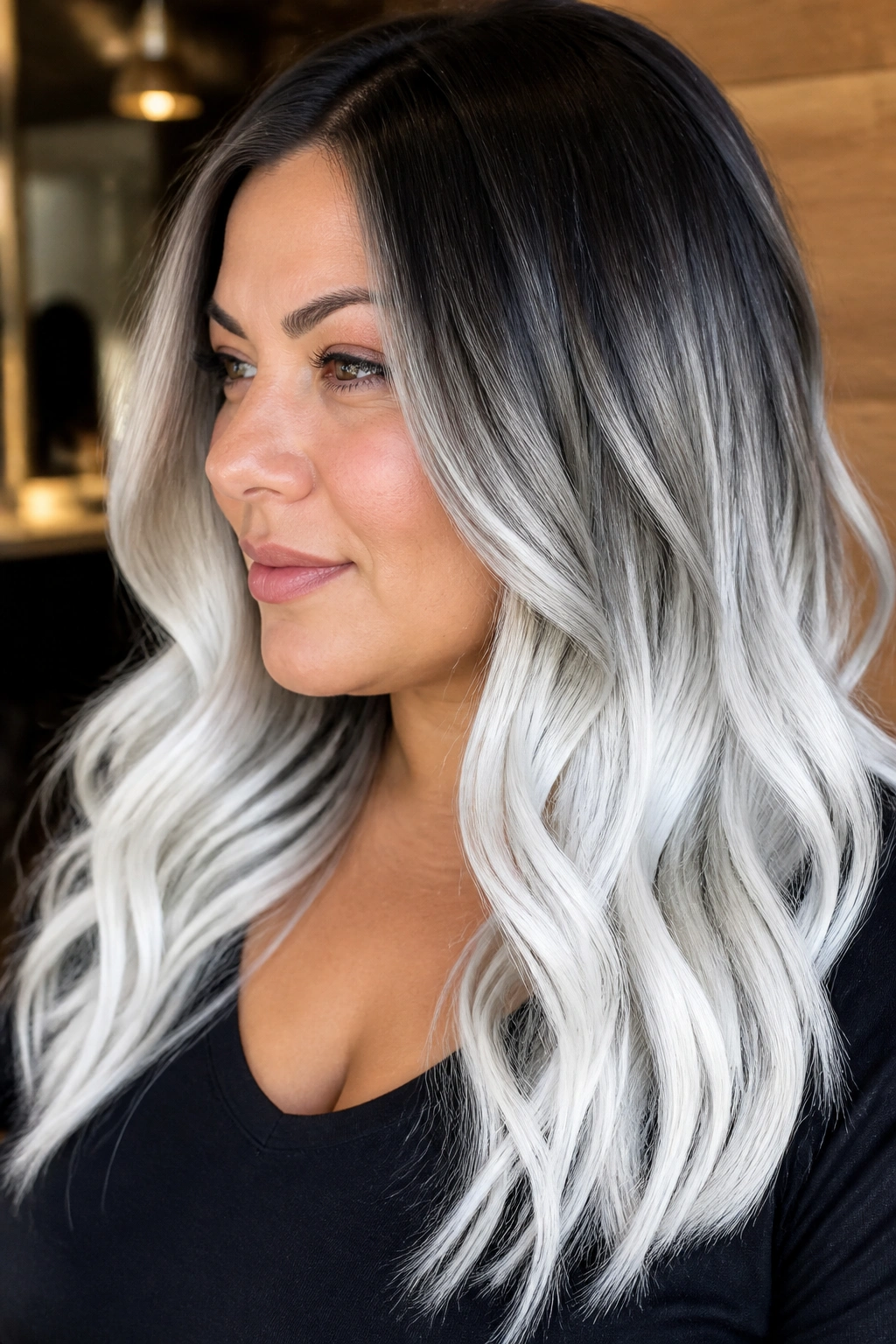Close-up of a real person with white ombré hair from dark roots to white ends in a salon