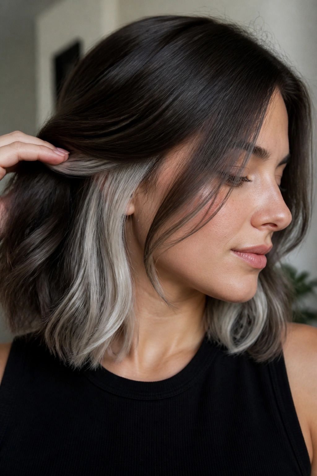 Close-up of a real person showcasing white underlights under a darker hair base.